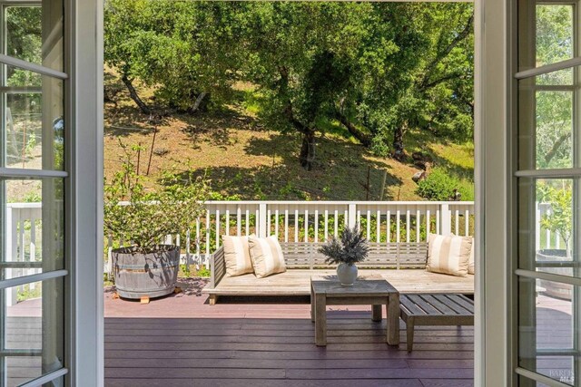 wooden terrace with an outdoor hangout area