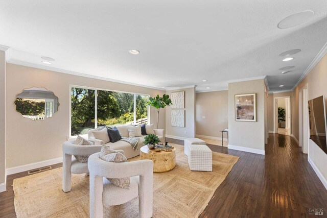 living room with crown molding, baseboards, visible vents, and dark wood-type flooring