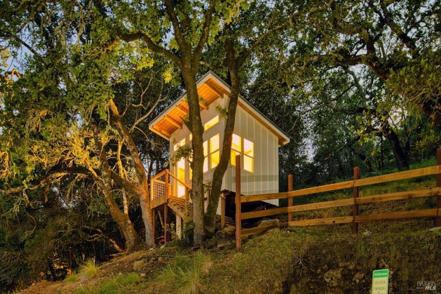 view of side of home featuring fence