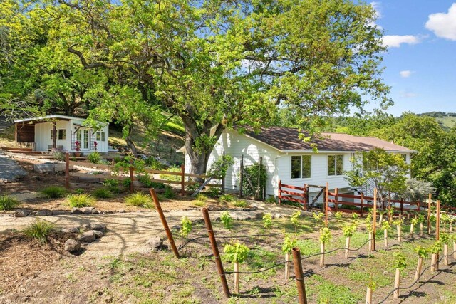 view of yard with fence and an outdoor structure