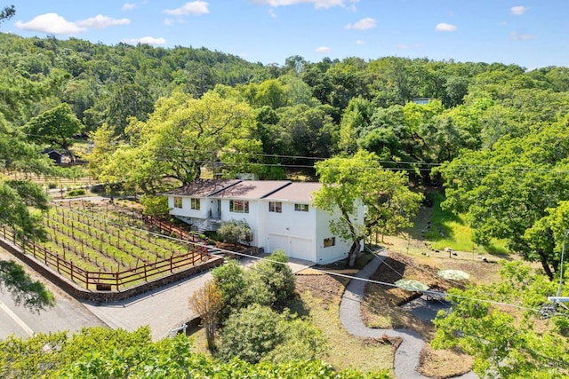 birds eye view of property with a forest view