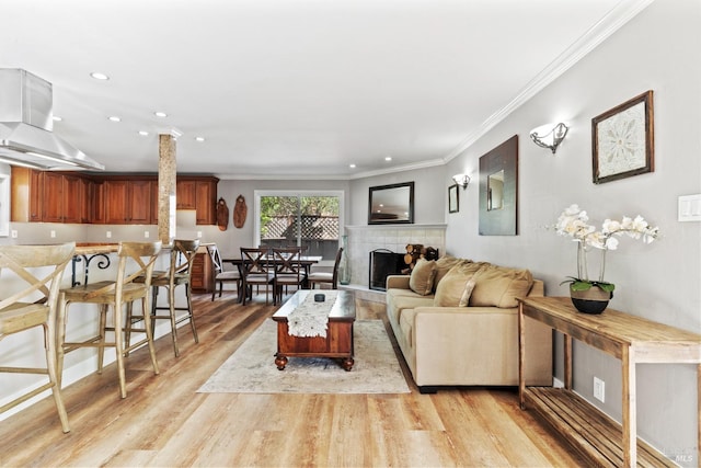 28 Washington St, Novato, CA 94947 - living room featuring light wood-type flooring, ornamental molding, recessed lighting, and a tiled fireplace