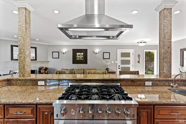 28 Washington St, Novato, CA 94947 - kitchen featuring wall chimney exhaust hood, stainless steel range with gas stovetop, decorative columns, open floor plan, and crown molding
