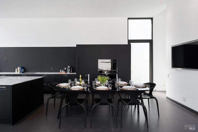 dining area featuring a high ceiling