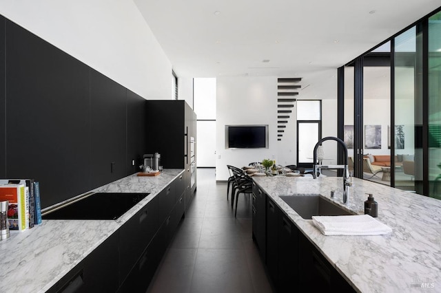 kitchen with dark cabinetry, black electric stovetop, and modern cabinets