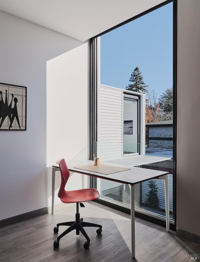 office featuring baseboards and wood finished floors