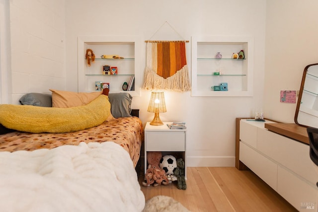 bedroom featuring baseboards and wood finished floors