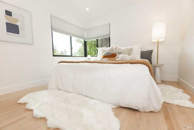bedroom with recessed lighting, baseboards, and wood finished floors