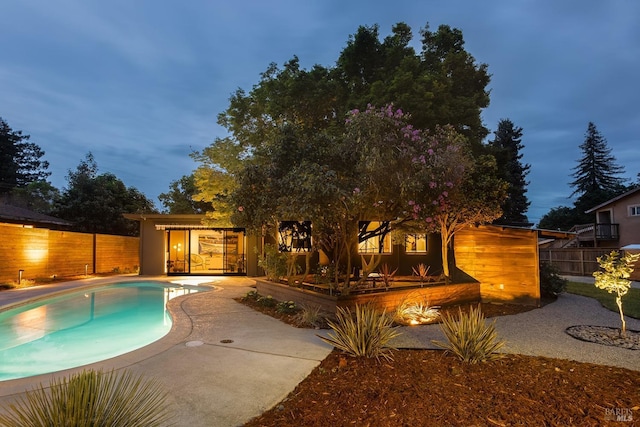 view of swimming pool featuring fence, a fenced in pool, and a patio area