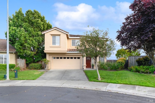 traditional-style home with driveway, a garage, fence, a front lawn, and stucco siding
