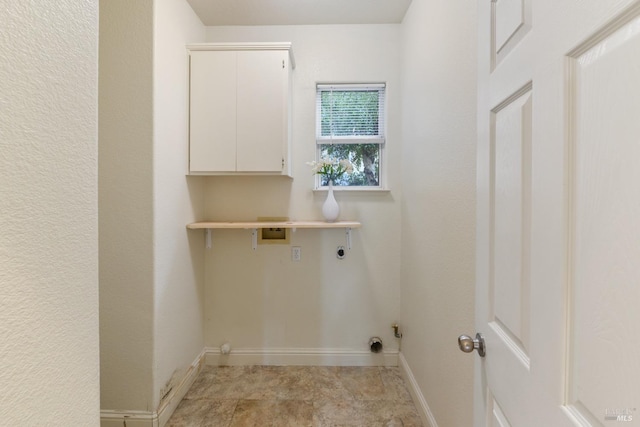 laundry area with hookup for an electric dryer, washer hookup, baseboards, and cabinet space