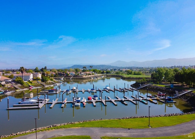 property view of water featuring a boat dock and a mountain view