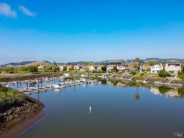 property view of water with a boat dock and a residential view