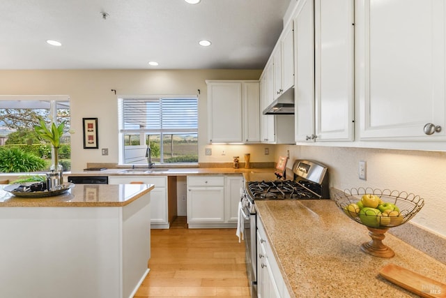 kitchen featuring a sink, stainless steel range with gas stovetop, recessed lighting, white cabinetry, and under cabinet range hood