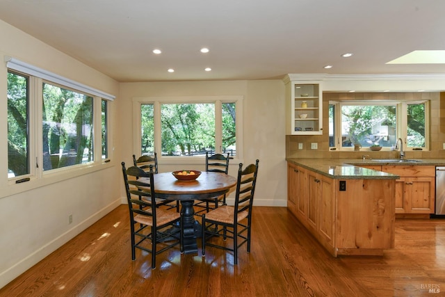 dining space with baseboards, recessed lighting, wood finished floors, and a wealth of natural light