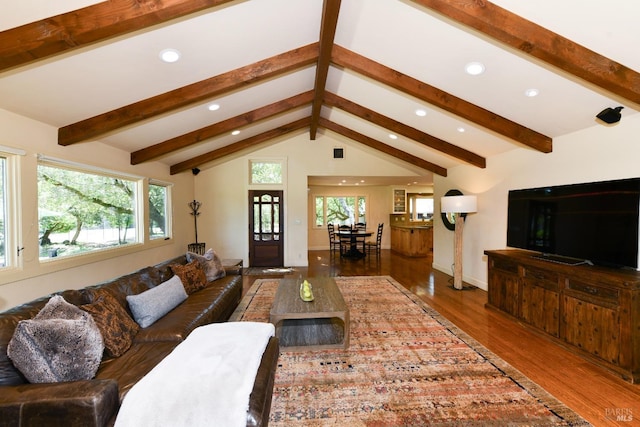 living area featuring baseboards, vaulted ceiling with beams, recessed lighting, and wood finished floors