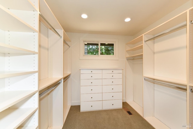 walk in closet featuring visible vents and light colored carpet