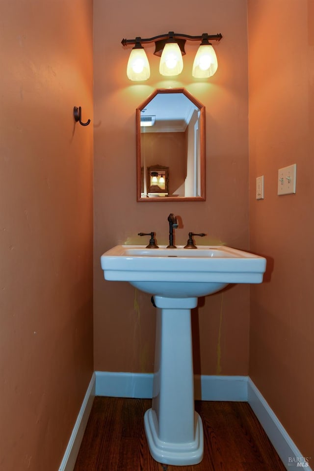 bathroom featuring baseboards and wood finished floors