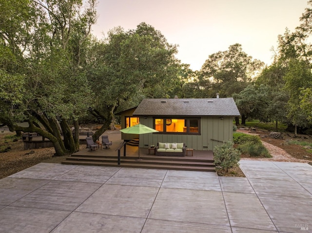 exterior space with an outdoor living space and a wooden deck