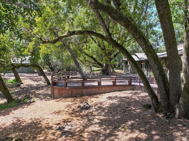 view of yard featuring fence and a deck