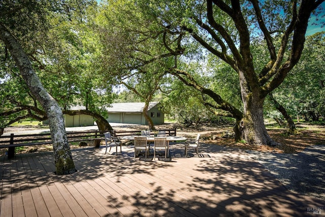 wooden terrace featuring outdoor dining space