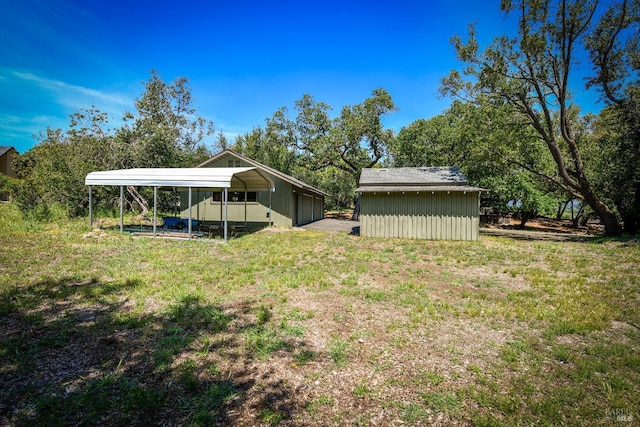 view of yard with a storage shed, an outdoor structure, and a carport