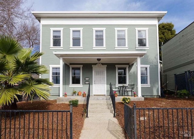 view of front of property featuring a porch and a fenced front yard