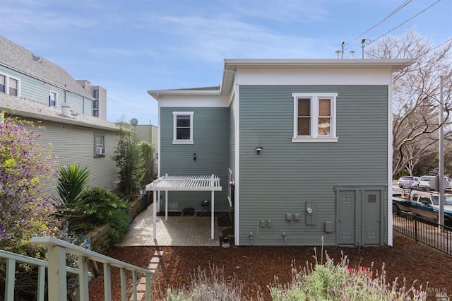 back of property with a patio and fence