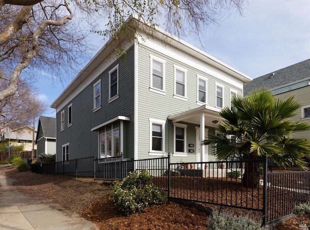 view of front facade featuring a porch and a fenced front yard