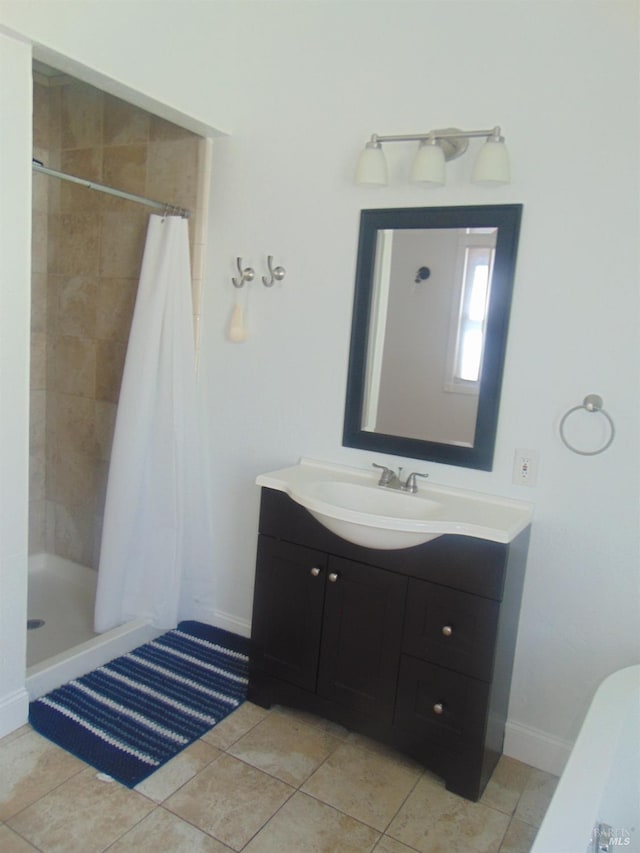 bathroom with vanity, tile patterned flooring, and a stall shower