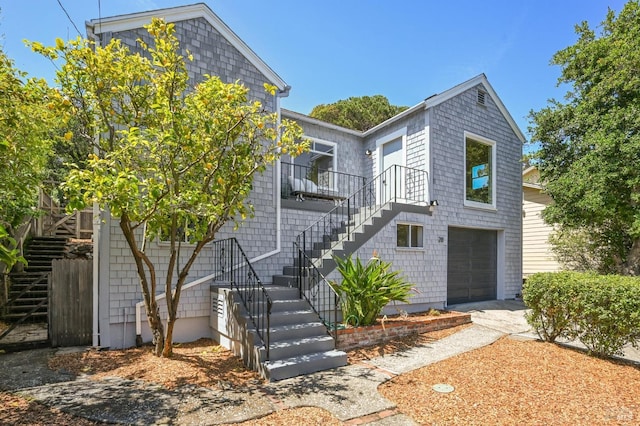 townhome / multi-family property with an attached garage and stairway