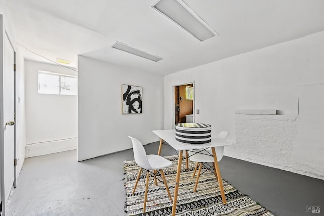 dining area with finished concrete floors and a healthy amount of sunlight