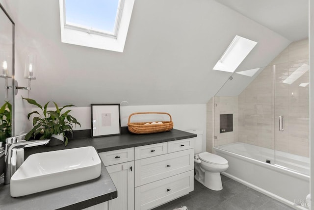269 Castro St, Lagunitas, CA 94938 - bathroom with vanity, tile patterned flooring, toilet, vaulted ceiling with skylight, and combined bath / shower with glass door