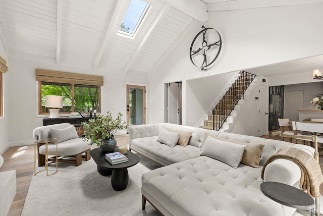 269 Castro St, Lagunitas, CA 94938 - living room featuring beam ceiling, light wood finished floors, high vaulted ceiling, a skylight, and stairway
