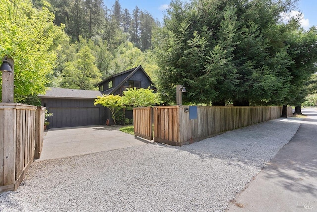 269 Castro St, Lagunitas, CA 94938 - view of property exterior featuring concrete driveway, fence, and a garage