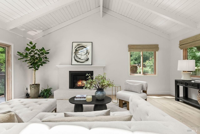269 Castro St, Lagunitas, CA 94938 - living area featuring a glass covered fireplace, baseboards, lofted ceiling with beams, and wood finished floors
