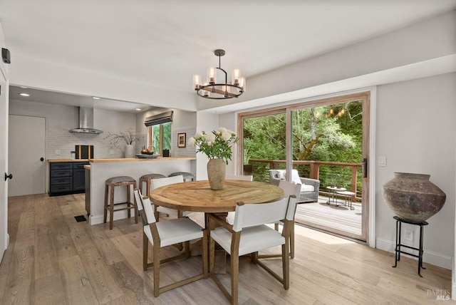 269 Castro St, Lagunitas, CA 94938 - dining room with light wood-style flooring, a chandelier, and a wealth of natural light