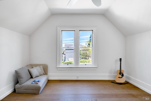 unfurnished room with a ceiling fan, vaulted ceiling, and wood finished floors