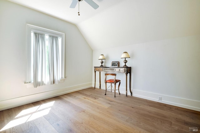 additional living space with a ceiling fan, baseboards, vaulted ceiling, and light wood-style flooring