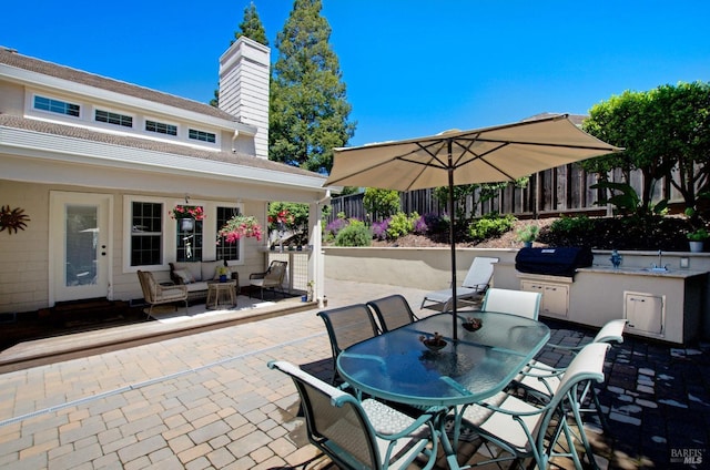 view of patio featuring fence, a grill, area for grilling, an outdoor living space, and outdoor dining space