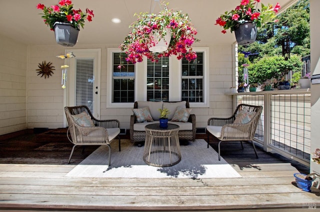 wooden terrace with an outdoor hangout area