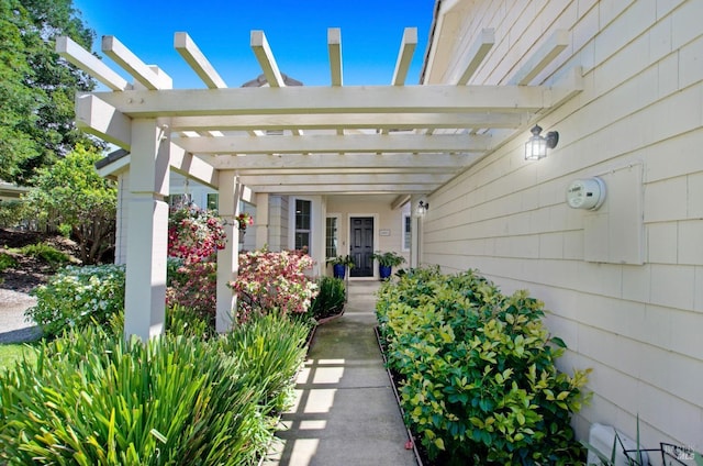 view of exterior entry featuring a pergola