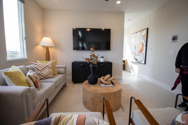 living area with recessed lighting and baseboards