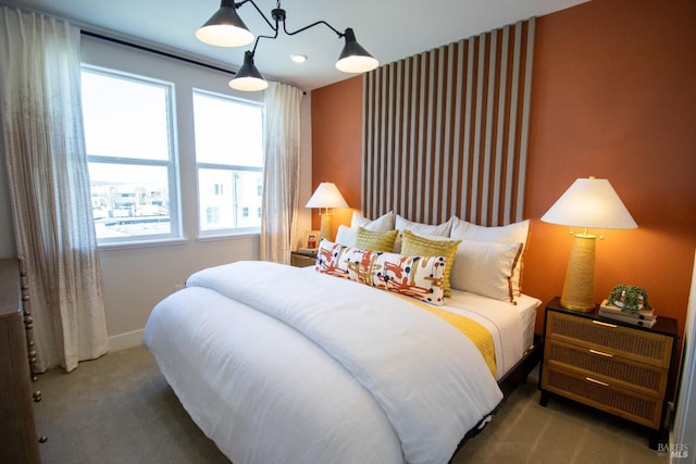 bedroom featuring baseboards, carpet flooring, and multiple windows