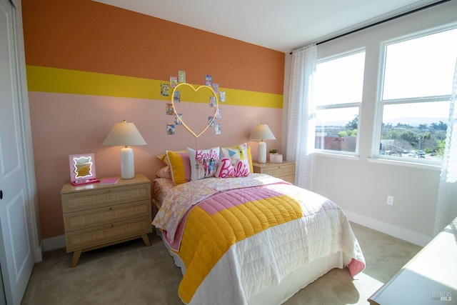 bedroom featuring baseboards, carpet, and multiple windows