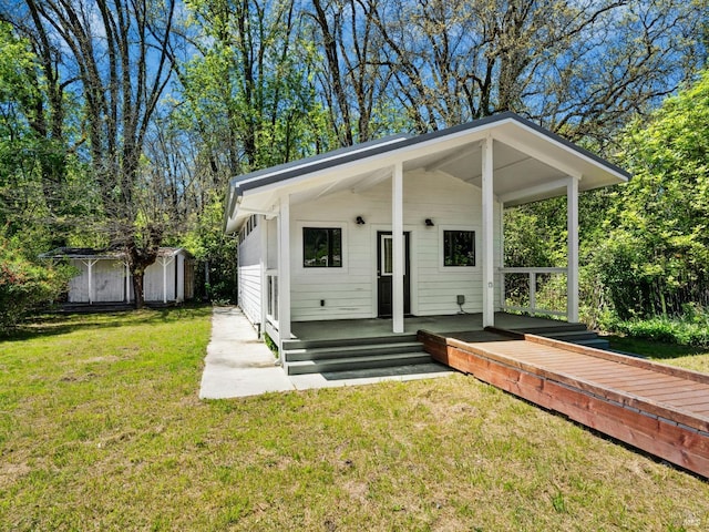 view of front facade with an outbuilding and a front yard