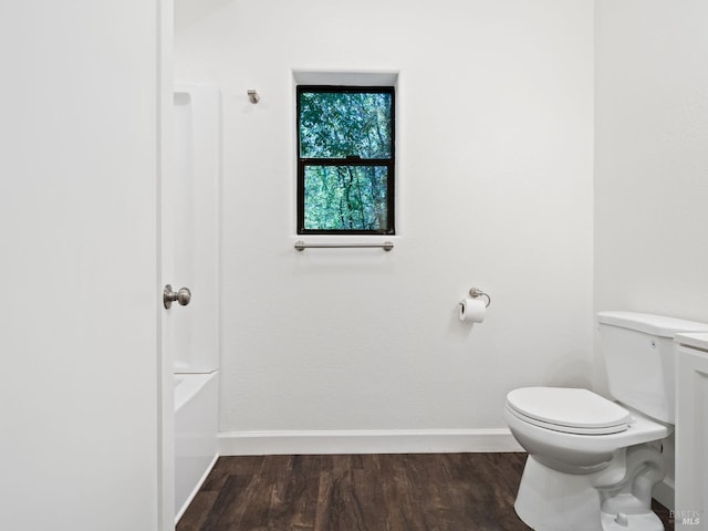 full bathroom with baseboards, wood finished floors, and toilet
