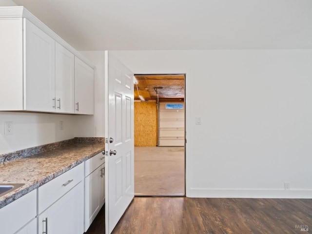 clothes washing area with dark wood-style flooring