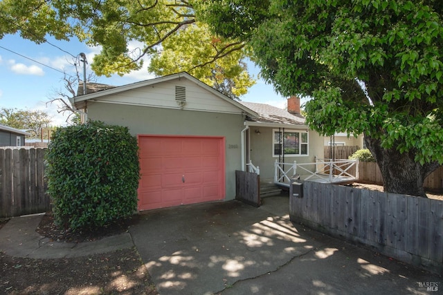 single story home featuring a garage, fence, stucco siding, a chimney, and driveway