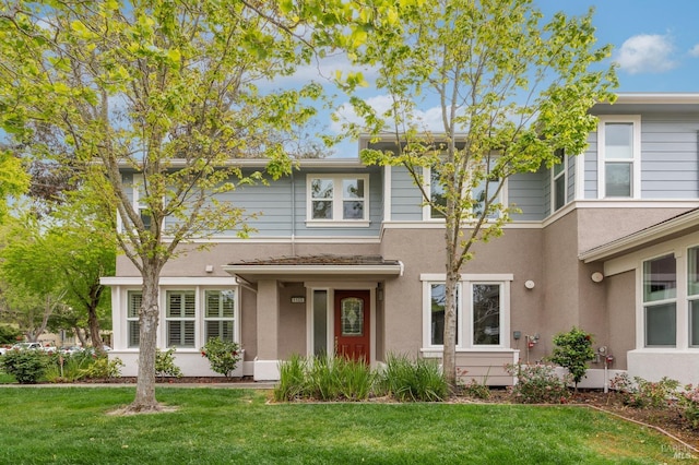 view of front of property with a front lawn and stucco siding